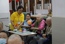 長者玩傳遞汽球遊戲時攝